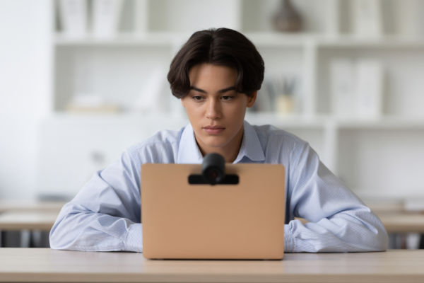 Student taking a secure online proctored exam with a webcam.