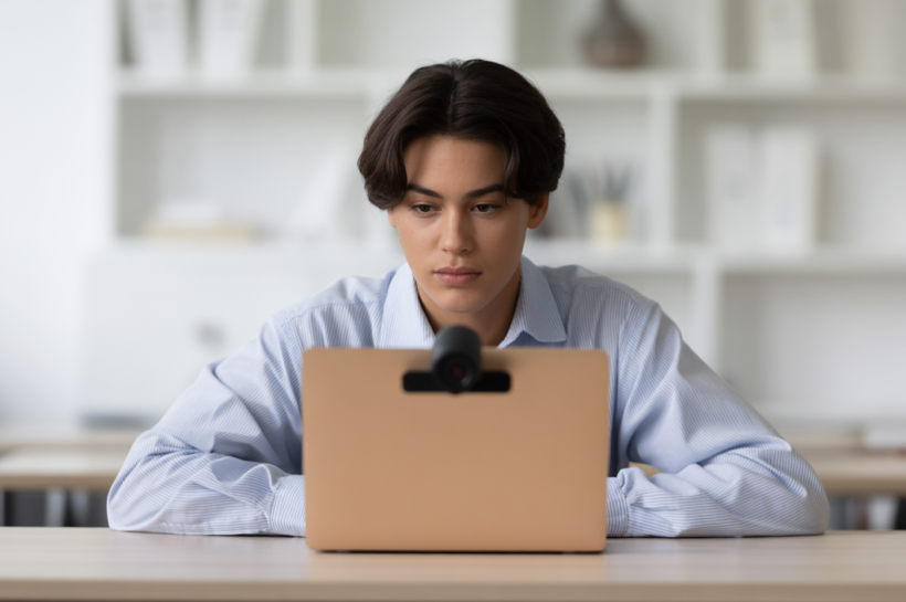 Student taking a secure online proctored exam with a webcam.